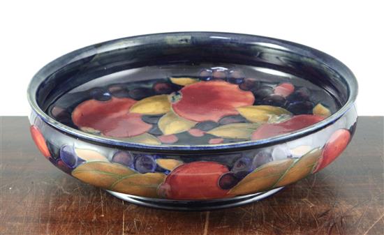 A William Moorcroft pomegranate blue ground footed shallow bowl, diameter 29cm